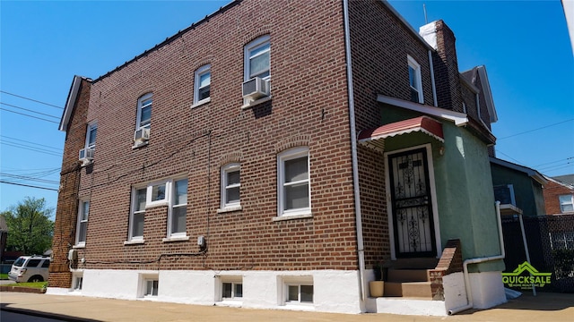 204-03 Murdock Ave, Saint Albans, NY 11412 - view of property exterior featuring brick siding and a chimney