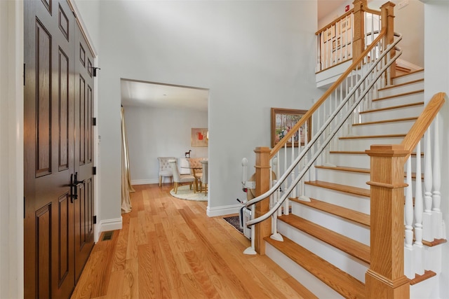9 Constance Ave, Dobbs Ferry, NY 10522 - entrance foyer featuring a towering ceiling, wood finished floors, stairs, and baseboards
