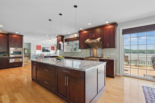 9 Constance Ave, Dobbs Ferry, NY 10522 - kitchen featuring oven, a warming drawer, light wood-style flooring, a center island, and hanging light fixtures