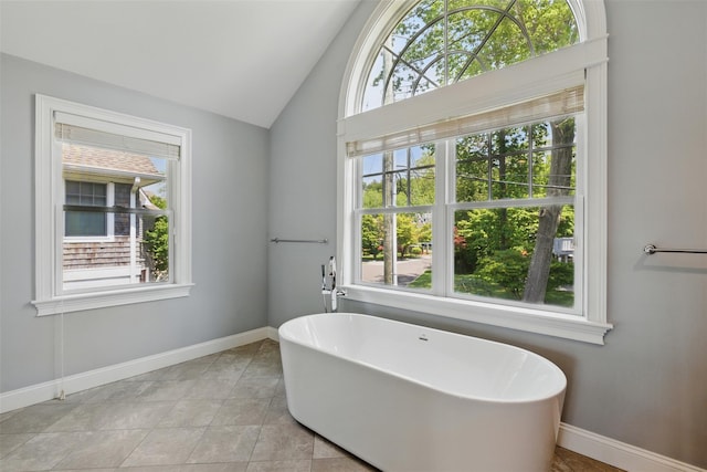 9 Constance Ave, Dobbs Ferry, NY 10522 - bathroom featuring a soaking tub, vaulted ceiling, baseboards, and tile patterned floors