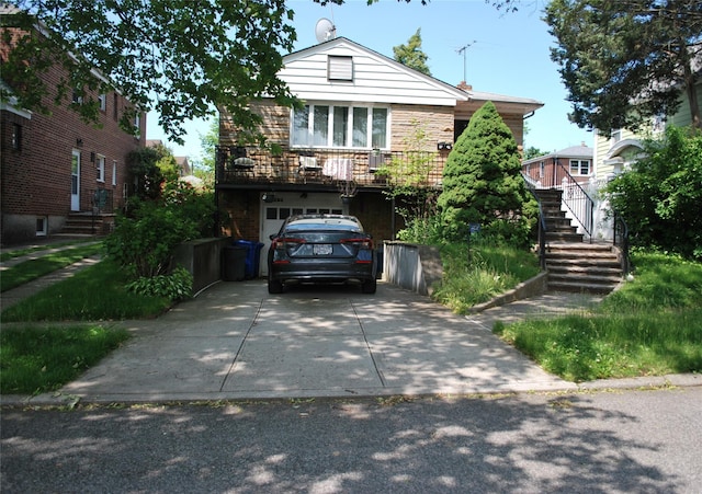 4026 208th St, Bayside, NY 11361 - view of front of property with concrete driveway, stairway, and an attached garage