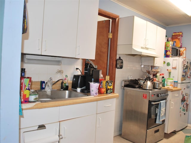 4026 208th St, Bayside, NY 11361 - kitchen featuring stainless steel range oven, under cabinet range hood, freestanding refrigerator, tasteful backsplash, and light countertops