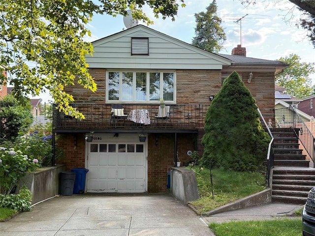 4026 208th St, Bayside, NY 11361 - view of front of house featuring stairway, a garage, concrete driveway, and a chimney