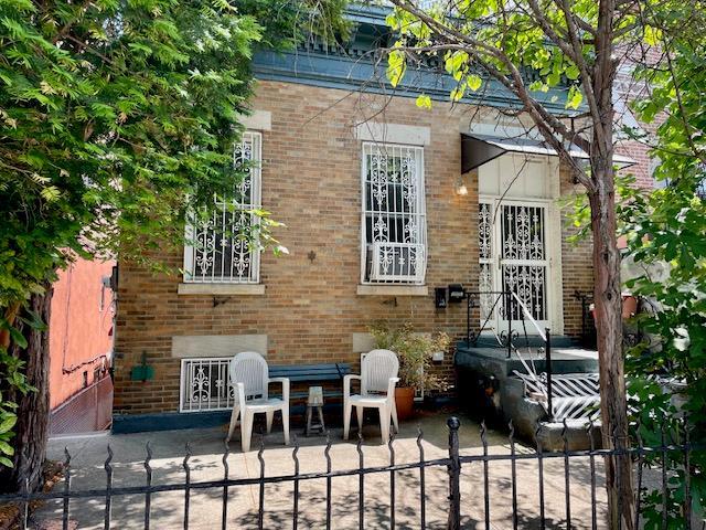 32-17 46th St, Astoria, NY 11103 - property entrance featuring brick siding and a patio area