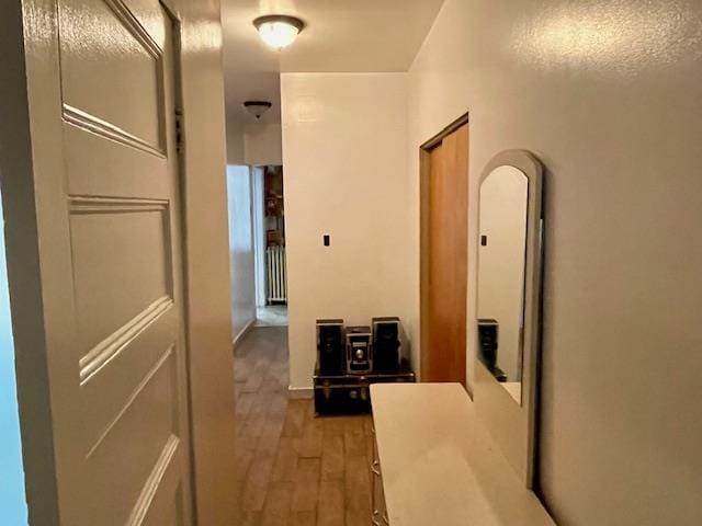 32-17 46th St, Astoria, NY 11103 - corridor with wood finished floors and radiator heating unit