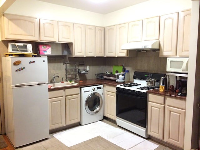 4231 Colden St Unit R6C, Flushing, NY 11355 - kitchen with washer / dryer, white appliances, under cabinet range hood, a sink, and backsplash
