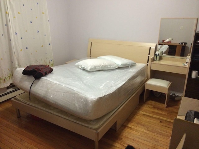 4231 Colden St Unit R6C, Flushing, NY 11355 - bedroom featuring light wood-style flooring and a baseboard radiator