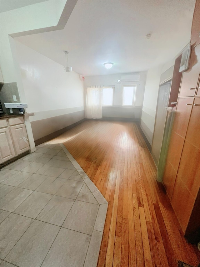 4231 Colden St Unit R6C, Flushing, NY 11355 - unfurnished living room with light wood finished floors and baseboards