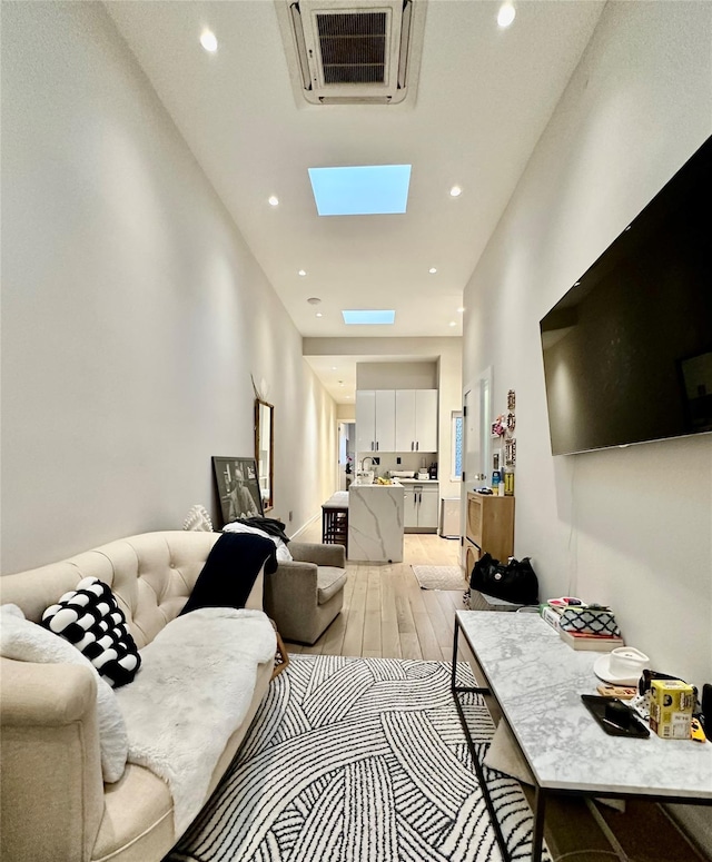 2564 38th St, Astoria, NY 11103 - living area featuring light wood finished floors, recessed lighting, and a skylight