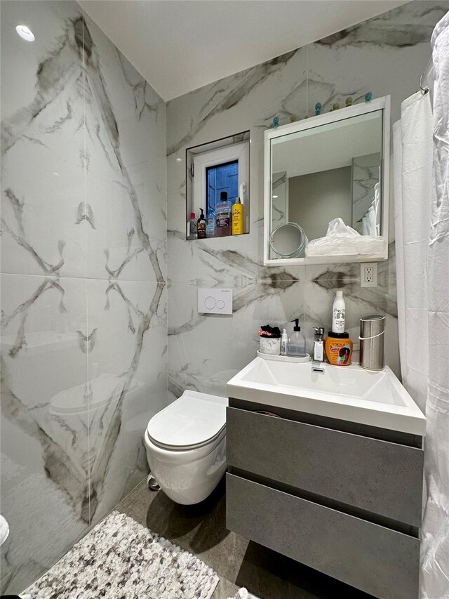 2564 38th St, Astoria, NY 11103 - bathroom featuring toilet, tile walls, and vanity