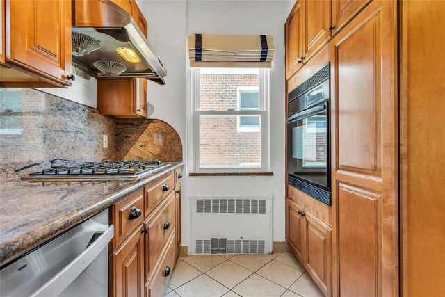 7931 211th St, Oakland Gardens, NY 11364 - kitchen with wall chimney exhaust hood, radiator heating unit, stainless steel appliances, tasteful backsplash, and brown cabinets