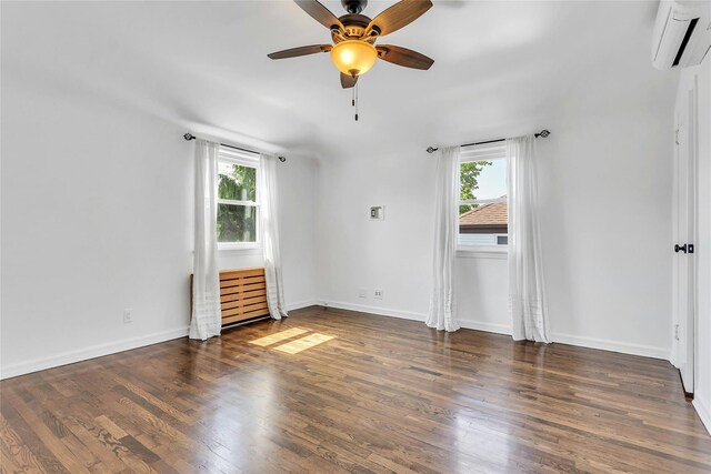 7931 211th St, Oakland Gardens, NY 11364 - empty room with a wall unit AC, plenty of natural light, wood finished floors, and a ceiling fan