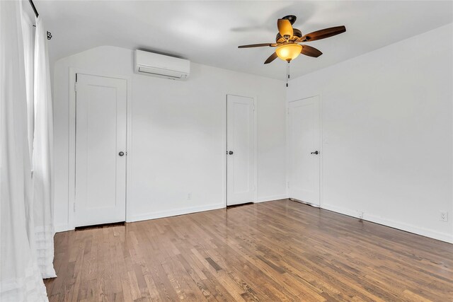 7931 211th St, Oakland Gardens, NY 11364 - unfurnished bedroom featuring a wall unit AC, wood finished floors, baseboards, a ceiling fan, and lofted ceiling