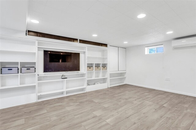 7931 211th St, Oakland Gardens, NY 11364 - unfurnished living room featuring a wall unit AC, wood finished floors, recessed lighting, and baseboards