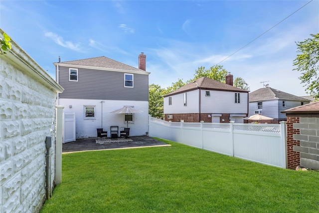 7931 211th St, Oakland Gardens, NY 11364 - back of property with a patio area and a chimney