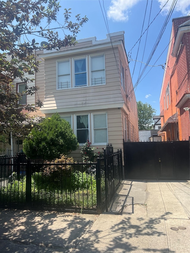 3758 100th St, Corona, NY 11368 - view of front facade featuring a fenced front yard and a gate