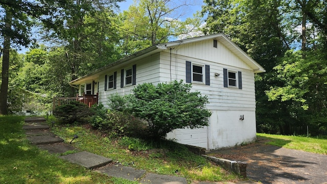 48 Julie Dr, Hopewell Junction, NY 12533 - view of side of home with an attached garage, a wooden deck, and driveway