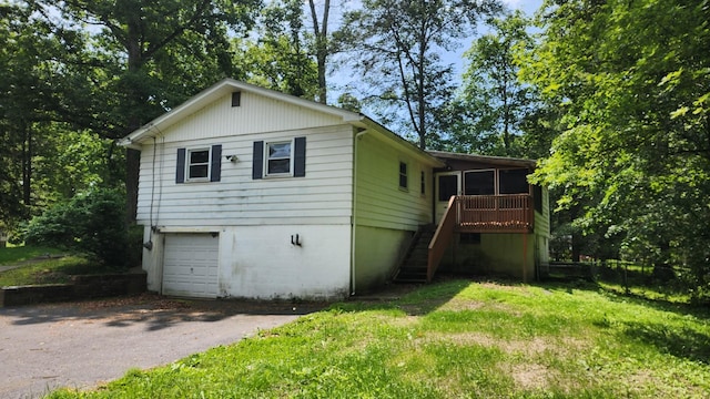 48 Julie Dr, Hopewell Junction, NY 12533 - view of front of home with stairs, driveway, a sunroom, an attached garage, and a front yard