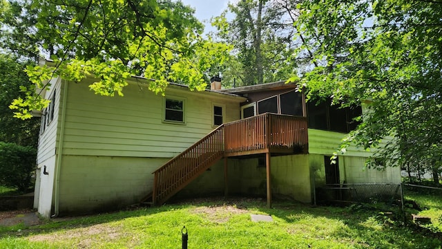 48 Julie Dr, Hopewell Junction, NY 12533 - back of property with a sunroom, stairway, a deck, and a chimney