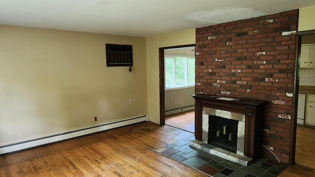 48 Julie Dr, Hopewell Junction, NY 12533 - unfurnished living room with a baseboard radiator, hardwood / wood-style flooring, a fireplace, and baseboards