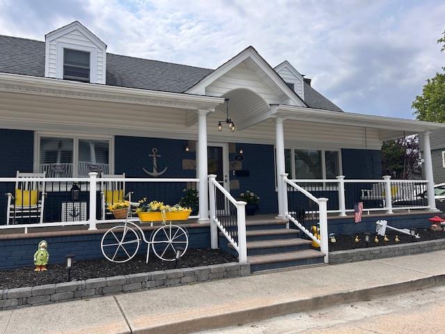 27 Armour St, Long Beach, NY 11561 - view of front of home with a porch and roof with shingles