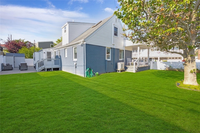 27 Armour St, Long Beach, NY 11561 - rear view of house featuring brick siding, a wooden deck, and central air condition unit