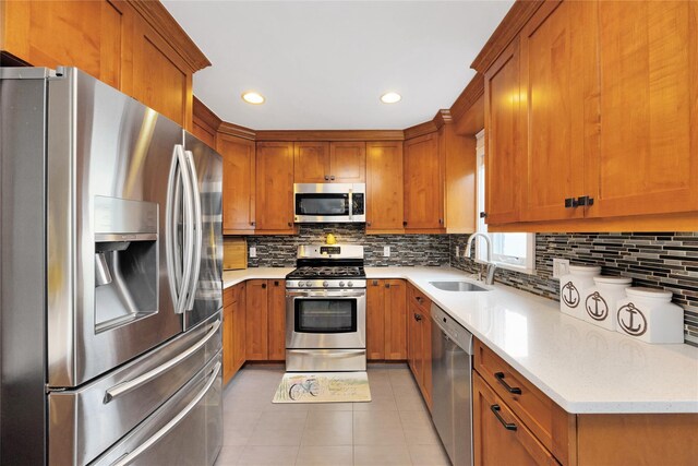 27 Armour St, Long Beach, NY 11561 - kitchen with appliances with stainless steel finishes, a sink, brown cabinets, light tile patterned floors, and backsplash