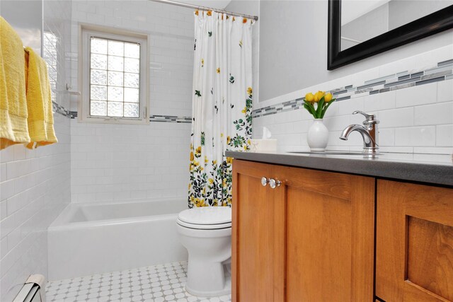 27 Armour St, Long Beach, NY 11561 - full bathroom with a baseboard radiator, toilet, shower / tub combo with curtain, vanity, and tile walls