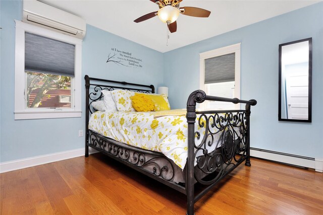 27 Armour St, Long Beach, NY 11561 - bedroom with a wall mounted AC, multiple windows, and wood finished floors