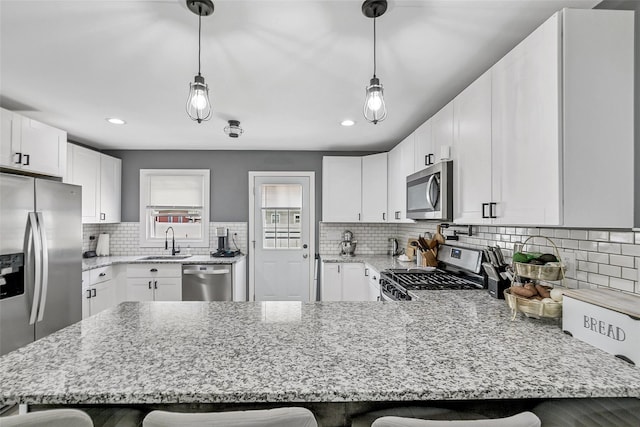 26 Richard Ave, Ronkonkoma, NY 11779 - kitchen with appliances with stainless steel finishes, a breakfast bar area, a peninsula, and recessed lighting