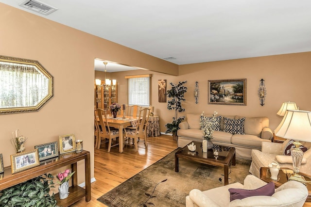 1197 Tulip Ave, Franklin Square, NY 11010 - living area with a chandelier and light wood-style floors
