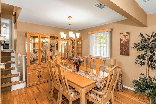 1197 Tulip Ave, Franklin Square, NY 11010 - dining room featuring a chandelier, light wood-style flooring, and baseboards