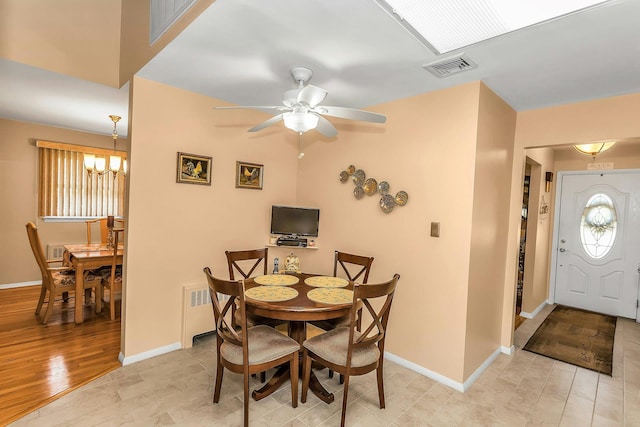1197 Tulip Ave, Franklin Square, NY 11010 - dining space with radiator heating unit, a ceiling fan, baseboards, light wood finished floors, and a chandelier