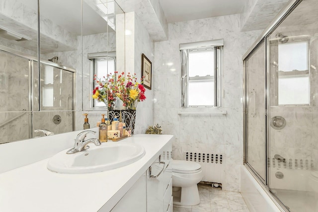 1197 Tulip Ave, Franklin Square, NY 11010 - full bathroom featuring radiator, toilet, tile walls, vanity, and healthy amount of natural light