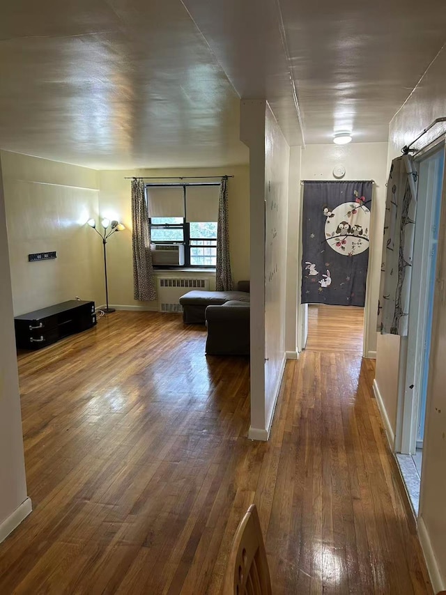 2625 141st St Unit 5A, Flushing, NY 11354 - corridor featuring radiator heating unit, wood-type flooring, and baseboards
