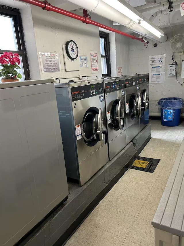 2625 141st St Unit 5A, Flushing, NY 11354 - shared laundry featuring washing machine and clothes dryer, plenty of natural light, and tile patterned floors