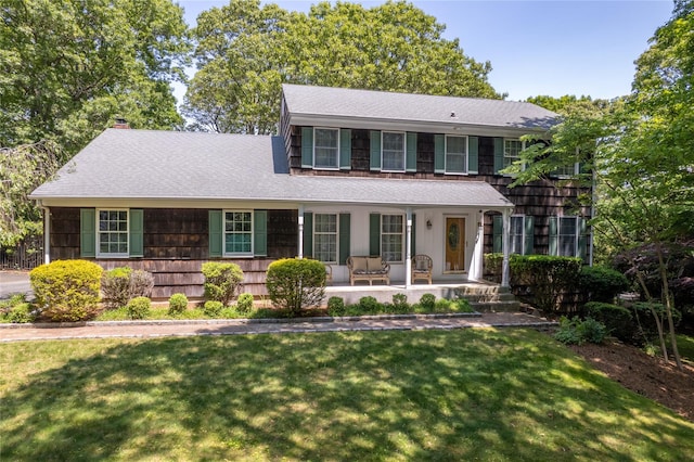 12 Cordwood Path, Shoreham, NY 11786 - view of front of home featuring a porch, a front lawn, a shingled roof, and a chimney