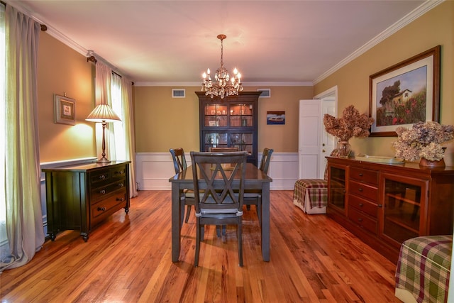 12 Cordwood Path, Shoreham, NY 11786 - dining room with a chandelier, crown molding, wood finished floors, and wainscoting