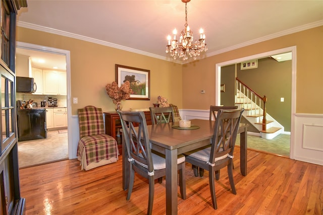 12 Cordwood Path, Shoreham, NY 11786 - dining room featuring a chandelier, stairs, ornamental molding, wainscoting, and light wood-style flooring