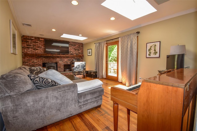12 Cordwood Path, Shoreham, NY 11786 - living room with a skylight, hardwood / wood-style flooring, crown molding, a wood stove, and recessed lighting