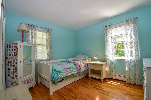 12 Cordwood Path, Shoreham, NY 11786 - bedroom featuring wood finished floors and baseboard heating