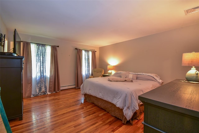 12 Cordwood Path, Shoreham, NY 11786 - bedroom with light wood-style flooring and baseboard heating