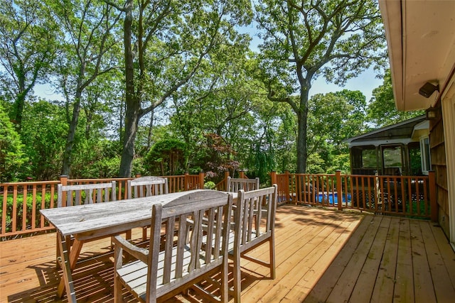 12 Cordwood Path, Shoreham, NY 11786 - wooden terrace with outdoor dining space and view of scattered trees