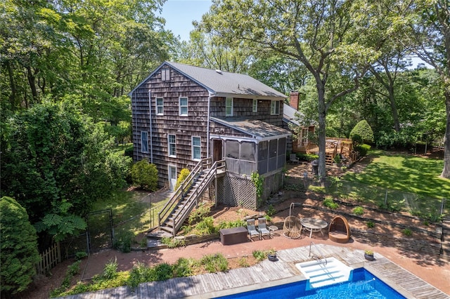 12 Cordwood Path, Shoreham, NY 11786 - rear view of house featuring stairway, a sunroom, a fenced backyard, a chimney, and a patio