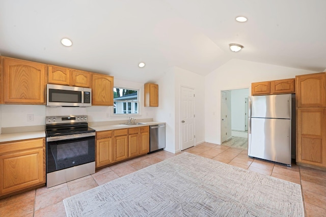 138 Greene Ave, Port Jefferson Station, NY 11776 - kitchen with appliances with stainless steel finishes, a sink, lofted ceiling, light countertops, and light tile patterned floors