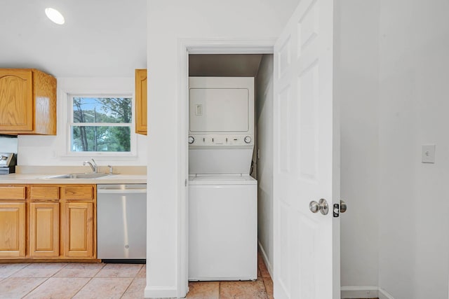 138 Greene Ave, Port Jefferson Station, NY 11776 - laundry area featuring stacked washer and clothes dryer and baseboards