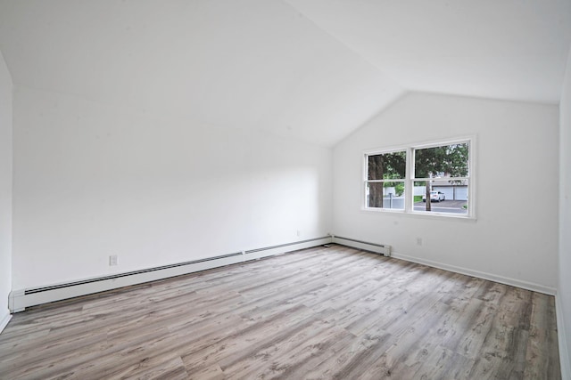 138 Greene Ave, Port Jefferson Station, NY 11776 - additional living space featuring wood finished floors, vaulted ceiling, a baseboard radiator, and baseboards