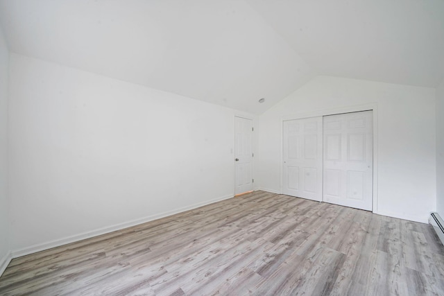 138 Greene Ave, Port Jefferson Station, NY 11776 - unfurnished bedroom with vaulted ceiling, wood finished floors, a closet, and baseboards
