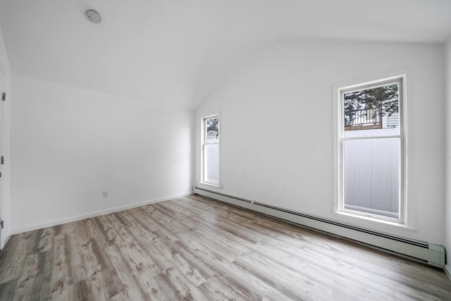 138 Greene Ave, Port Jefferson Station, NY 11776 - empty room with baseboard heating, vaulted ceiling, and light wood-type flooring