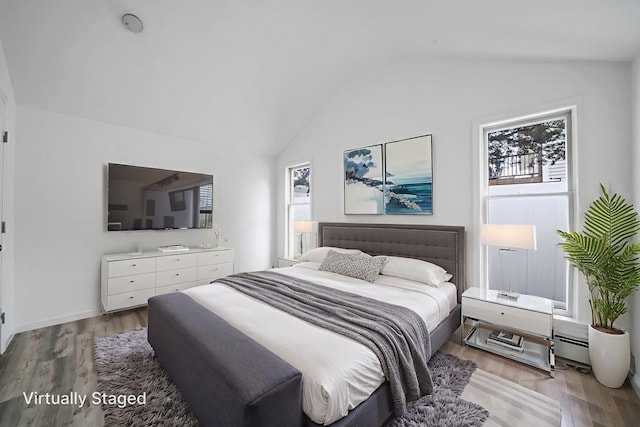 138 Greene Ave, Port Jefferson Station, NY 11776 - bedroom featuring vaulted ceiling, multiple windows, and light wood-style floors